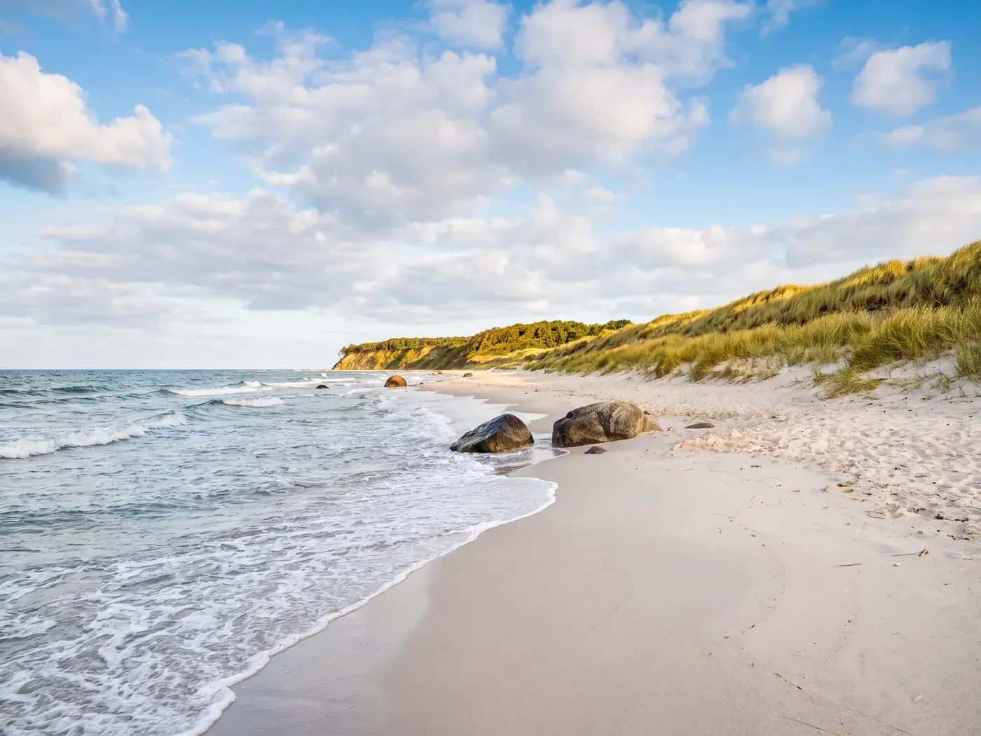 Wide Baltic Sea beach with dunes and glacial boulders