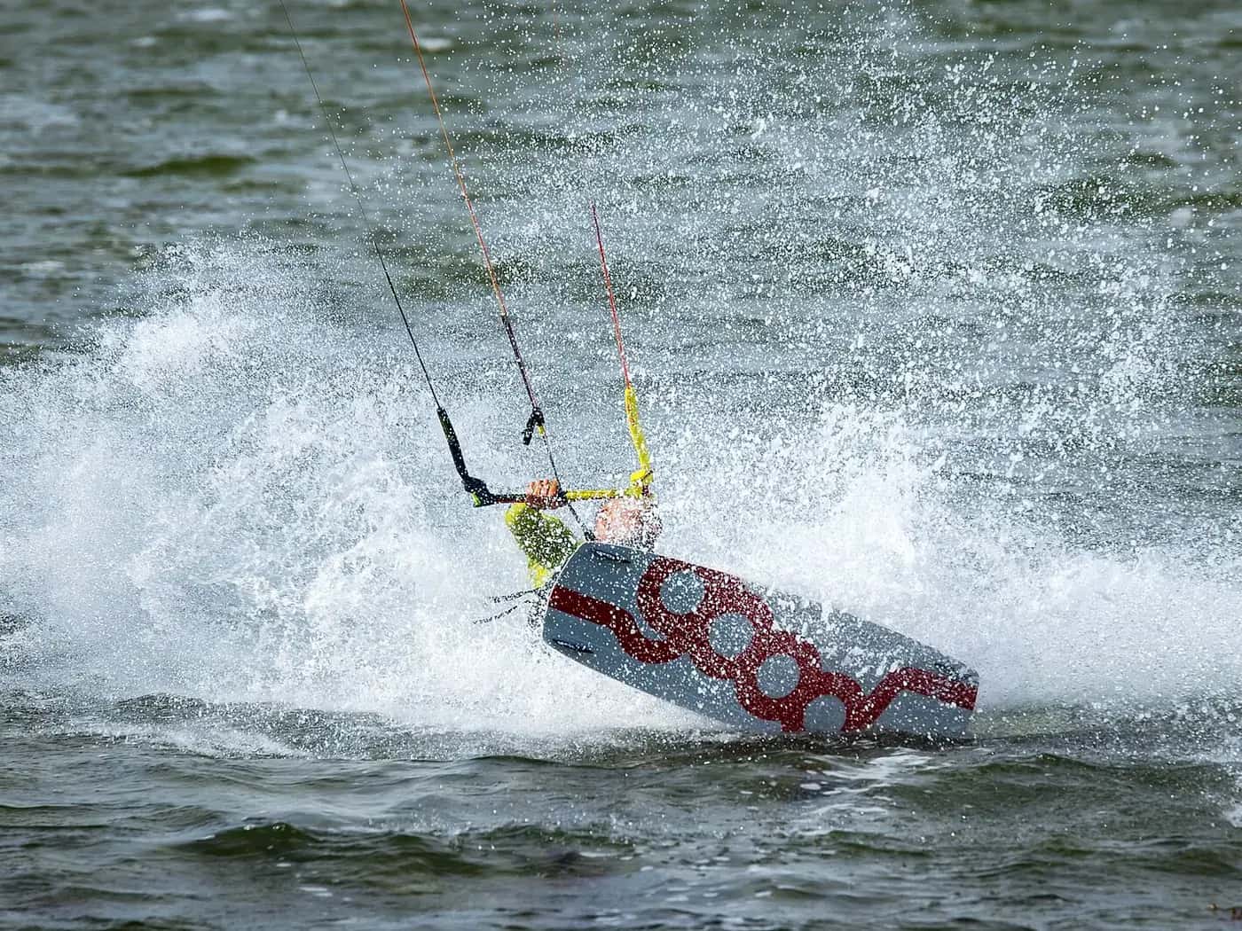 Kitesurfer jumping through the spray off the coast of Fehmarn